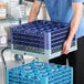 A Noble Warewashing 25-compartment gray full-size glass rack with four blue extenders.