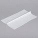 Durable Packaging white interfolded deli sheets on a gray surface.