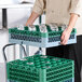 A Noble Warewashing 36-compartment gray full-size glass rack with one green extender, used for holding and washing glassware.