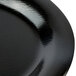 A close up of a textured black oval GET platter.