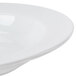 A CAC Harmony white porcelain soup bowl with a thin rim on a white surface.