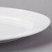 A close-up of a CAC white porcelain platter with a rim.