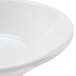 A close-up of a CAC white porcelain fruit bowl with a white rim.