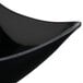 A close up of a black GET San Michele melamine bowl with a curved edge.