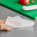 A hand using WipesPlus Lemon Scent surface disinfecting wipes to clean a counter.