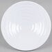 A white round melamine bowl with a spiral design on it.