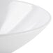 A close-up of a white GET San Michele slanted melamine bowl with a curved rim.