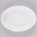 A white oval baker dish on a gray surface.
