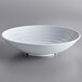 A case of six white Milano melamine bowls on a gray surface.