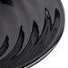 A close up of a black bowl with a wavy design.