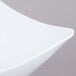 A close up of a white GET San Michele Flare Bowl with a curved edge.