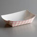 A white rectangular paper food container with a red and white checkered pattern.
