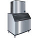 A large stainless steel ice maker with a black and silver adapter kit.