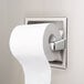 A Bobrick recessed toilet tissue dispenser with an extra roll of toilet paper stored inside.