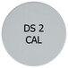 A white circular Edlund calibration weight with black text reading "DS-2 2 kg"