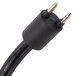 A close-up of a black power cord with two metal plugs.