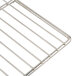 A stainless steel wire rack with a handle for an Avantco countertop food warmer.