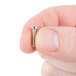 A person holding a small silver Waring screw.