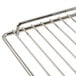 A stainless steel Avantco wire rack with a handle.