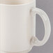 A close up of a Homer Laughlin ivory stackable china mug with a handle.