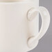 A close up of a Homer Laughlin ivory china jumbo mug with a handle.