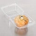 A muffin in a Polar Pak clear plastic takeout container.