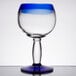 A Libbey Aruba cocktail glass with a blue rim and base.