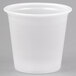 A close up of a Solo translucent plastic souffle cup on a white surface.
