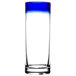 A close-up of a clear Libbey shooter glass with a cobalt blue rim.