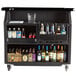 A Cambro black portable bar with bottles of alcohol on it.