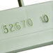 A close-up of a light green Vollrath plastic tag with the number 52670.