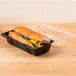 A sandwich in a Polar Pak clear and black hinged take-out container.