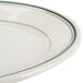 A close-up of a Homer Laughlin white oval platter with a green stripe on the rim.