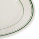 A close up of a Homer Laughlin white oval platter with green stripes on the edge.