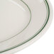 A close-up of a white Homer Laughlin oval platter with green trim.