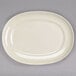 A white oval Homer Laughlin china platter on a gray surface.