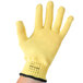 A yellow glove with a black wrist.