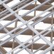 A close up of a white plastic grid with white bars.
