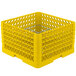 A yellow plastic Vollrath Traex Plate Crate with 12 compartments and holes on the top.