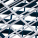 A close up of a white metal grid with white bars.