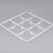 A white plastic grid tray with 9 compartments and holes.