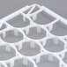 A white plastic Vollrath glass rack trim divider with eight holes.