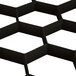 A black Vollrath Traex glass rack extender with white hexagon grids.