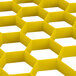 A yellow hexagon-shaped Vollrath Traex glass rack extender.