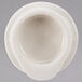A white bowl with a Homer Laughlin Seville Ivory beverage server lid on top.