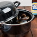A black Hendi enameled steel pot with mussels inside.