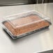 A brownie in a Solut plastic container with a clear lid on a counter.