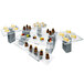 A group of food on a table with Eastern Tabletop stainless steel magnetic block risers.