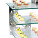 A display of desserts on Eastern Tabletop stainless steel "L" shaped risers with three integrated levels.