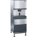 A silver and black Follett ice machine with a water dispenser.